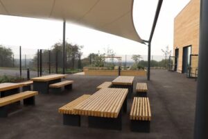 Tables and b4enches in an outside space at Trent View College