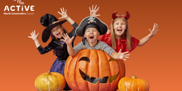 Children in Halloween fancy dress with pumpkins
