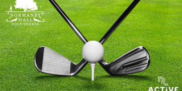 Golf clubs and golf ball on a green