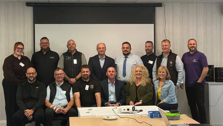Two rows of business people in front of a desk