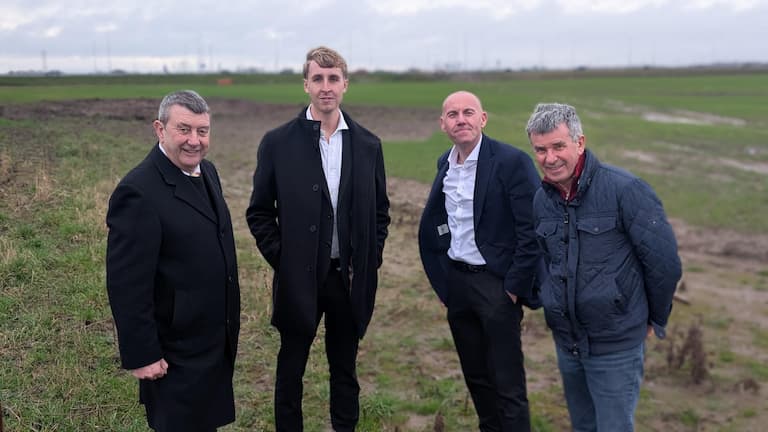 Four men standing in a field