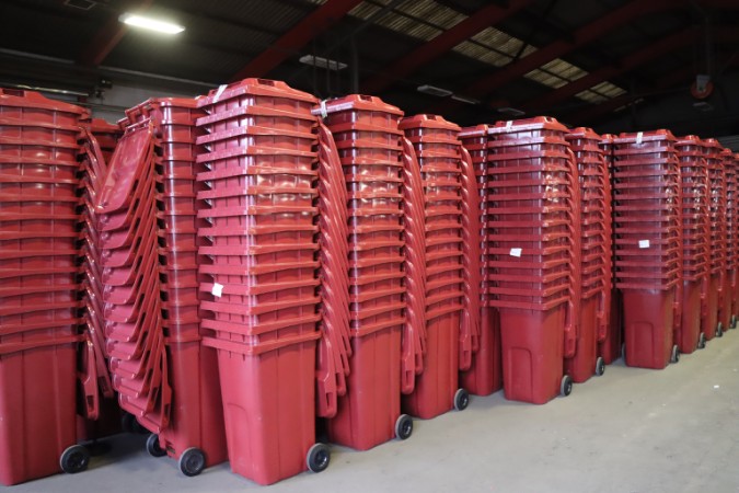 Stacks of burgundy bins