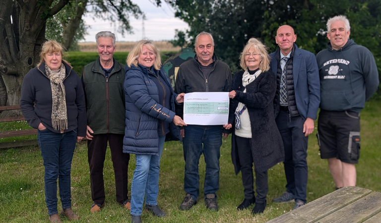 Members of Burton upon Stather Heritage Group with Cllr Rob Waltham and Cllr Elaine Marper holding a big cheque