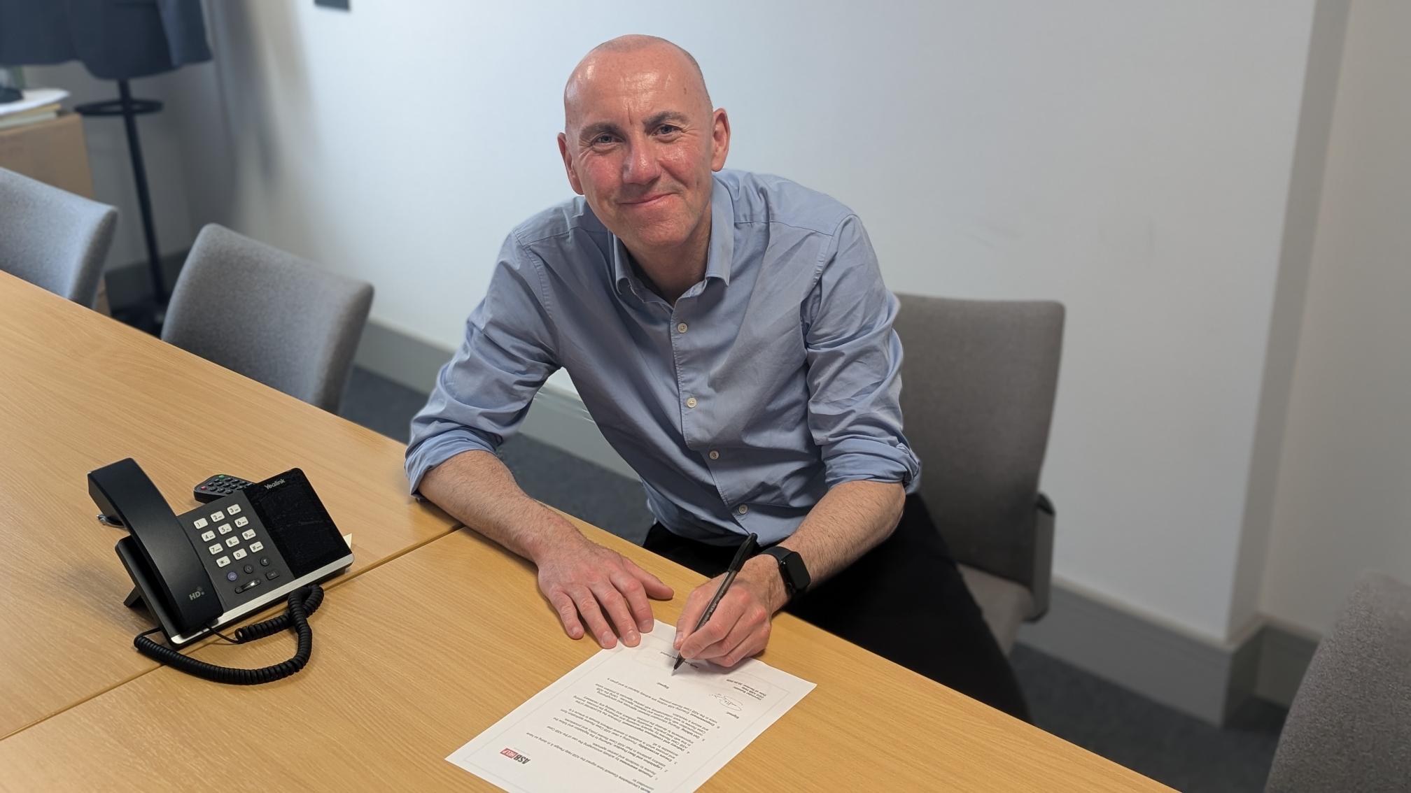 A photo of Cllr Rob Waltham signing the ASB Help Pledge