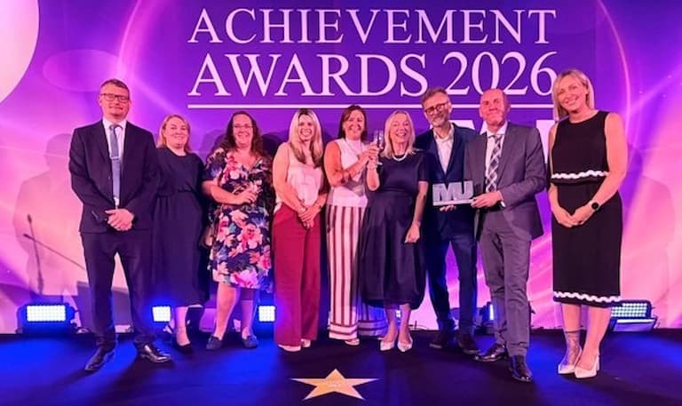 A line of nine people at an award ceremony